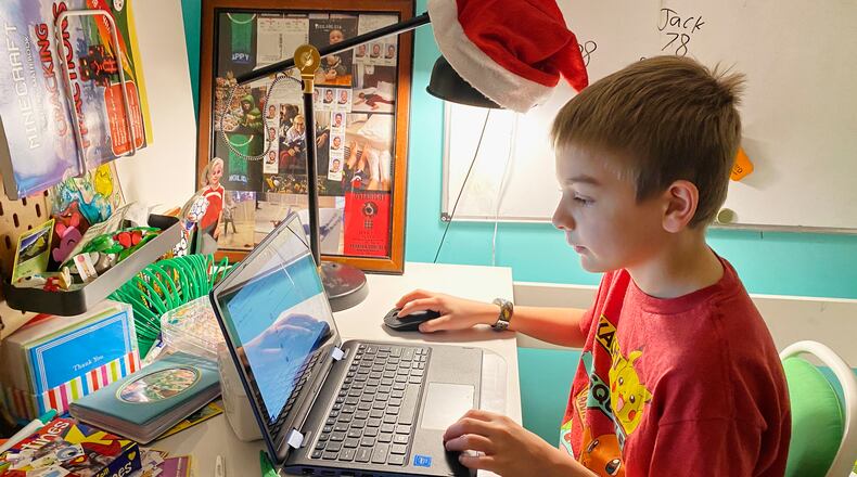 This April 9, 2020, photo released by Kara Illig shows her son, Eli Illig, 10, on his computer in Ebensburg, Pa. The frustration of parents is mounting as more families across the U.S. enter their second or even third week of total distance learning, and some say it will be their last. (Kara Illig via AP)