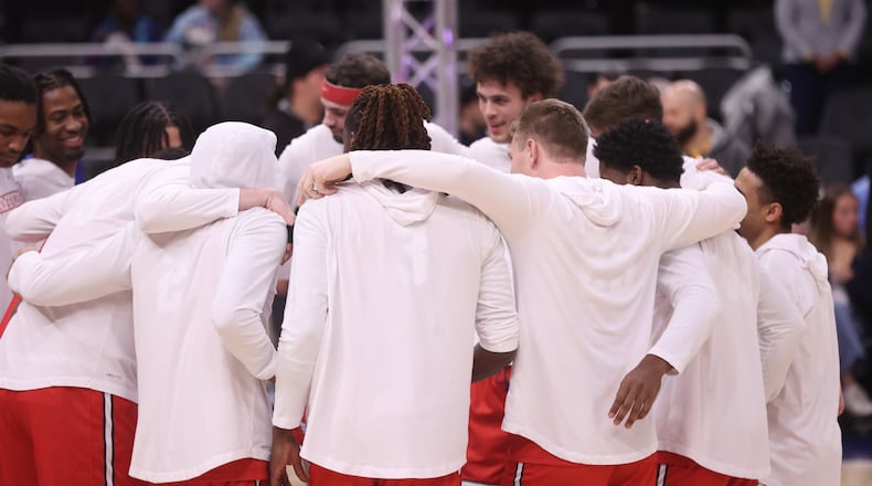 Dayton huddles before a game against Marquette on Wednesday, Nov. 19, 2025, at Fiserv Arena in Milwaukee, Wis. David Jablonski/Staff