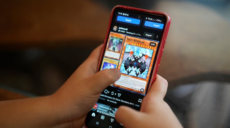 A boy uses a social media platform in Brasilia, Brazil, Thursday, March 19, 2026. A new law regulating children’s use of social media took effect this week, requiring users under 16 to link their accounts to a legal guardian. (AP Photo/Eraldo Peres)
