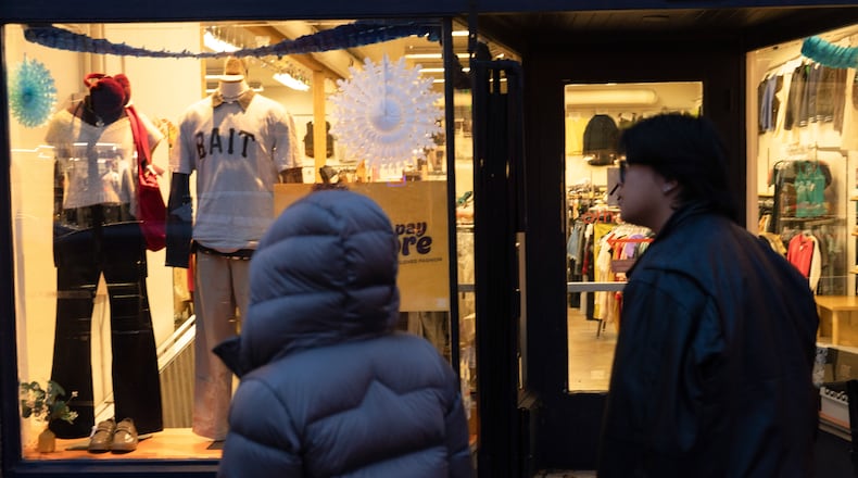 People walk by a shop on Tuesday, Jan. 6, 2026, in Portland, Ore. (AP Photo/Jenny Kane)