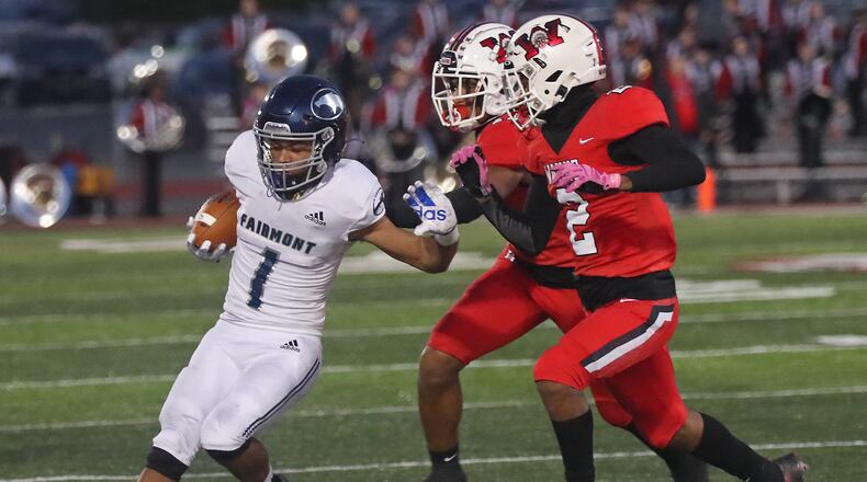 Fairmont's Kamron Payne is chased out of bounds by Wayne's Elisiah Lovett and Dray Wilson during Friday's game. BILL LACKEY/STAFF