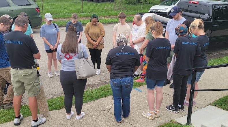 Prayer and community service are central to the work of Oasis House.
Pictured: Volunteers and Oasis House residents gather together.
Submitted.
