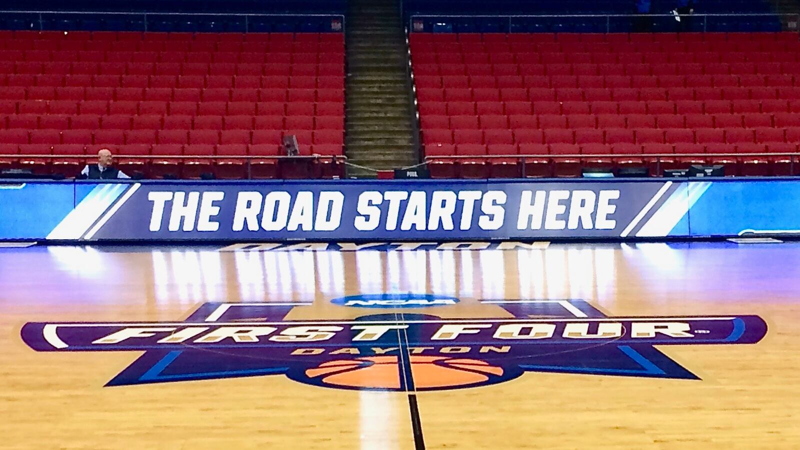 Mid-court sign, "The Road Starts Here" at the First Four at UD Arena in Dayton, Ohio.