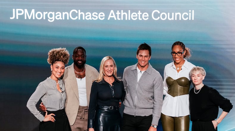 Kristin Lemkau, CEO, J.P. Morgan Wealth Management, center left, poses for a picture with, from left, Ally Love, Peloton Instructor + VP, Instructor Strategy & Development, Dwyane Wade, former NBA basketball player, Tom Brady, former NFL football player, A'ja Wilson WNBA basketblal player, and Meg Rapinoe, former women's soccer player, during a Pro Athlete event at JPMorganChase headquarters in New York, Wednesday, March 18, 2026. (AP Photo/Eduardo Munoz Alvarez)