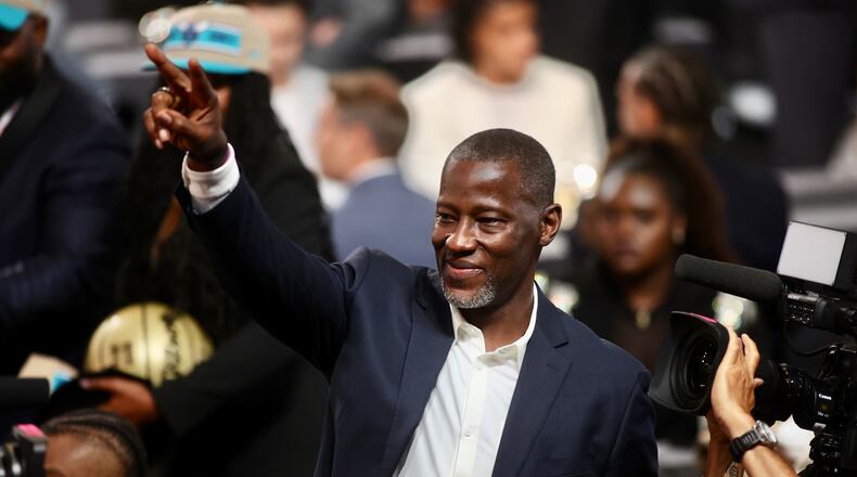 Dayton's Anthony Grant points to fans in the stands after DaRon Holmes II was selected with the No. 22 pick in the NBA Draft on Wednesday, June 26, 2024, at the Barclays Center in Brooklyn, N.Y. David Jablonski/Staff