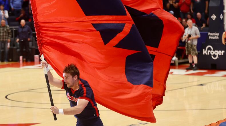 A Dayton cheerleader runs onto the court before a game against Saint Francis on Monday, Nov. 4, 2024, at UD Arena. David Jablonski/Staff