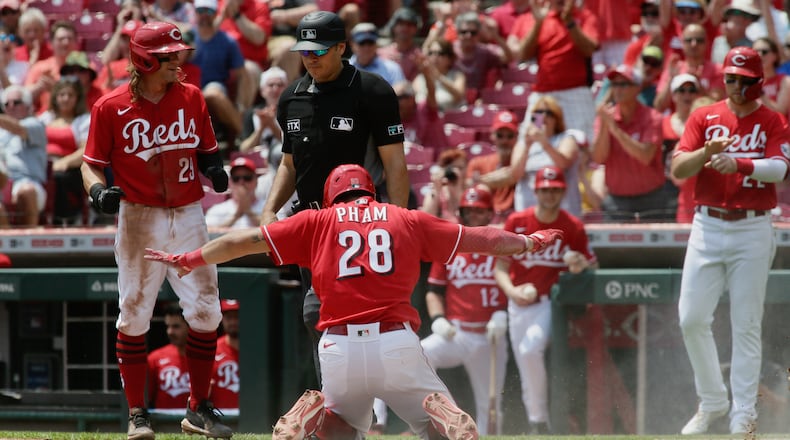 Tommy Pham, of the Reds, scores on a bases-clearing double by Tyler Stephenson in the second inning on Wednesday, May 11, 2022, at Great American Ball Park in Cincinnati. David Jablonski/Staff