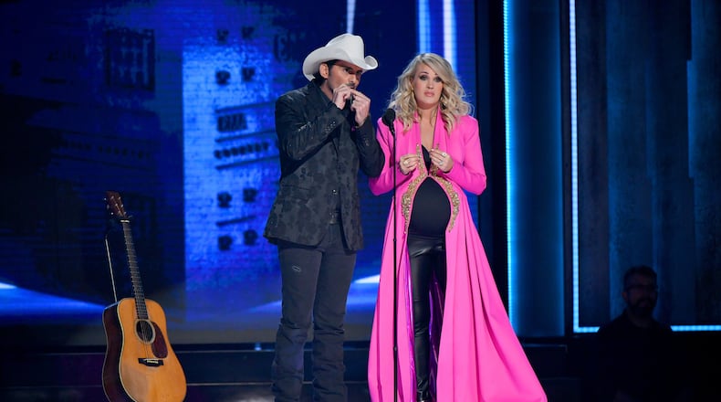 NASHVILLE, TN - NOVEMBER 14: (FOR EDITORIAL USE ONLY) Brad Paisley and Carrie Underwood speak onstage during the 52nd annual CMA Awards at the Bridgestone Arena on November 14, 2018 in Nashville, Tennessee. (Photo by Michael Loccisano/Getty Images)
