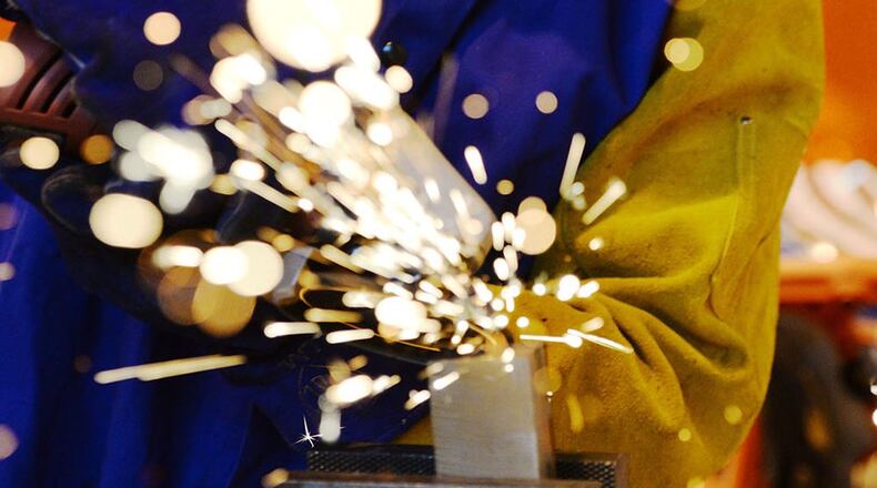 A welder with the Rapid Development Integration Facility grinds down some metal while working on a project inside the 20,000-square-foot manufacturing and modification facility at Wright-Patterson Air Force Base Dec. 2, 2015. Since its start, the RDIF has successfully returned more than $150 million to customers who can then use that money on additional projects. Additionally, the facility has enabled its customers to realize more than 70 percent cost savings and schedule time. (U.S. Air Force photo/Wesley Farnsworth)