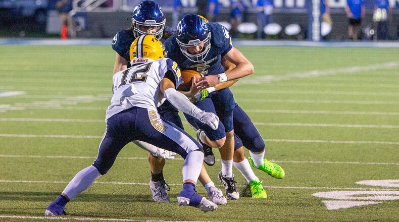 Fairmont quarterback Brock Baker takes on Springfield's Quenta Wafer Jr. during the Firebirds' first-half touchdown drive. Jeff Gilbert/CONTRIBUTED