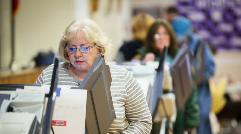 Lois Miller and others cast their votes at Amanda Elementary School in Middletown, Tuesday, Nov. 8, 2016. GREG LYNCH/STAFF
