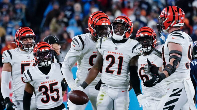 Cincinnati Bengals cornerback Mike Hilton (21) celebrates and interception he made against Tennessee Titans quarterback Ryan Tannehill (17) during the second half of an NFL divisional round playoff football game, Saturday, Jan. 22, 2022, in Nashville, Tenn. (AP Photo/Mark Humphrey)