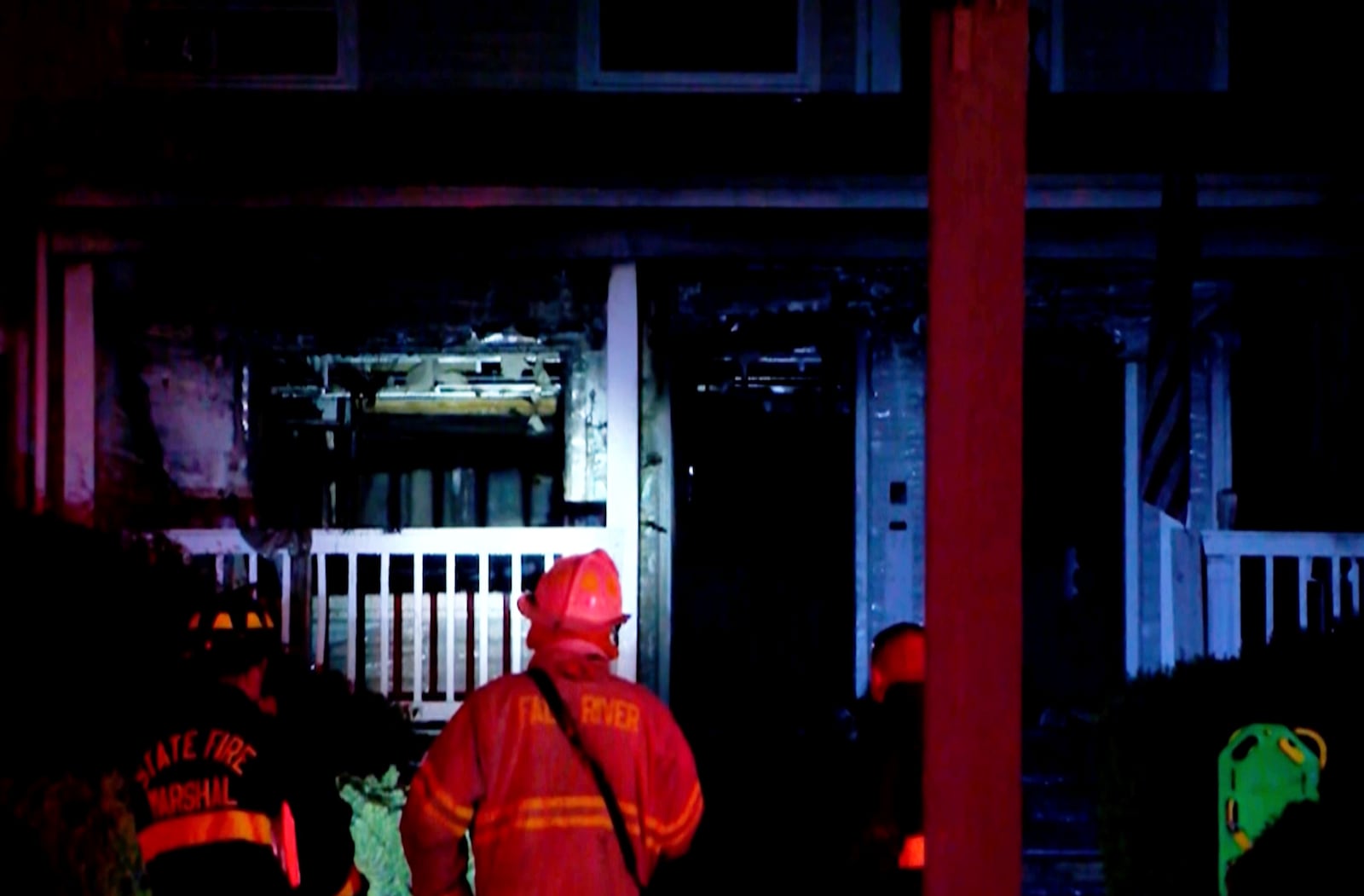 This image taken from video provided by WLNE-TV shows a firefighter working on the aftermath of a fire at an assisted living facility in Fall River, Mass., Sunday, July 13, 2025. (WLNE-TV via AP)