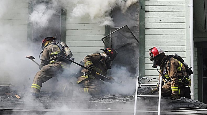 Firefighters at the scene of a house fire on South Terry Street on Feb. 22, 2018. Julie Dennis, 50, died six days later from her injuries, and her 23-year-old son was charged with aggravated arson and murder. MARSHALL GORBY / STAFF