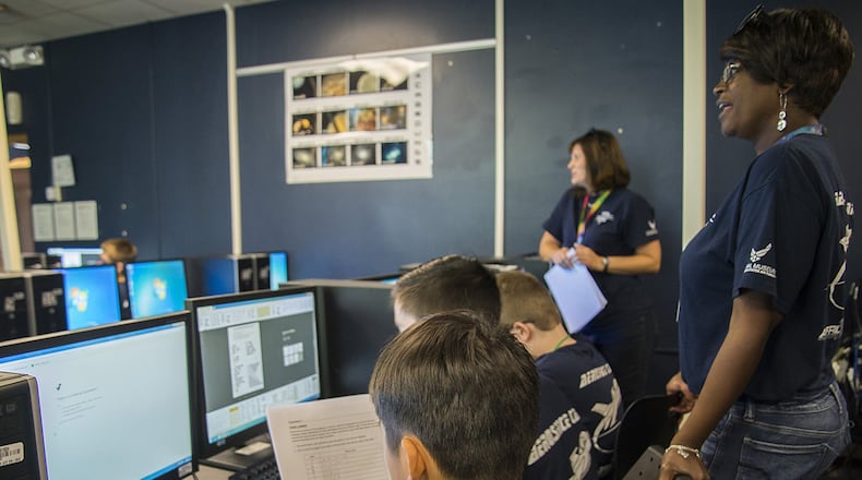 STARBASE instructor Susie Tyson gives directions on how to apply STEM (science, technology, engineering and math) concepts using Morse code for a potential real-world situation during a 2-day STARBASE camp for seventh and eighth graders on Wright-Patterson Air Force Base July 11. (U.S. Air Force photo/Karina Brady)