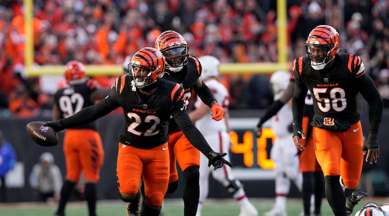 Cincinnati Bengals safety Geno Stone (22) celebrates with teammates after an interception during the second half of an NFL football game against the Cleveland Browns, Sunday, Dec. 22, 2024, in Cincinnati. (AP Photo/Jeff Dean)