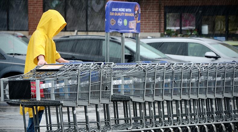 Neither rain nor snow or sleet will stop the return of shopping carts to the Kroger Market Place in Beavercreek, Wednesday, April 5, 2023. MARSHALL GORBY \STAFF