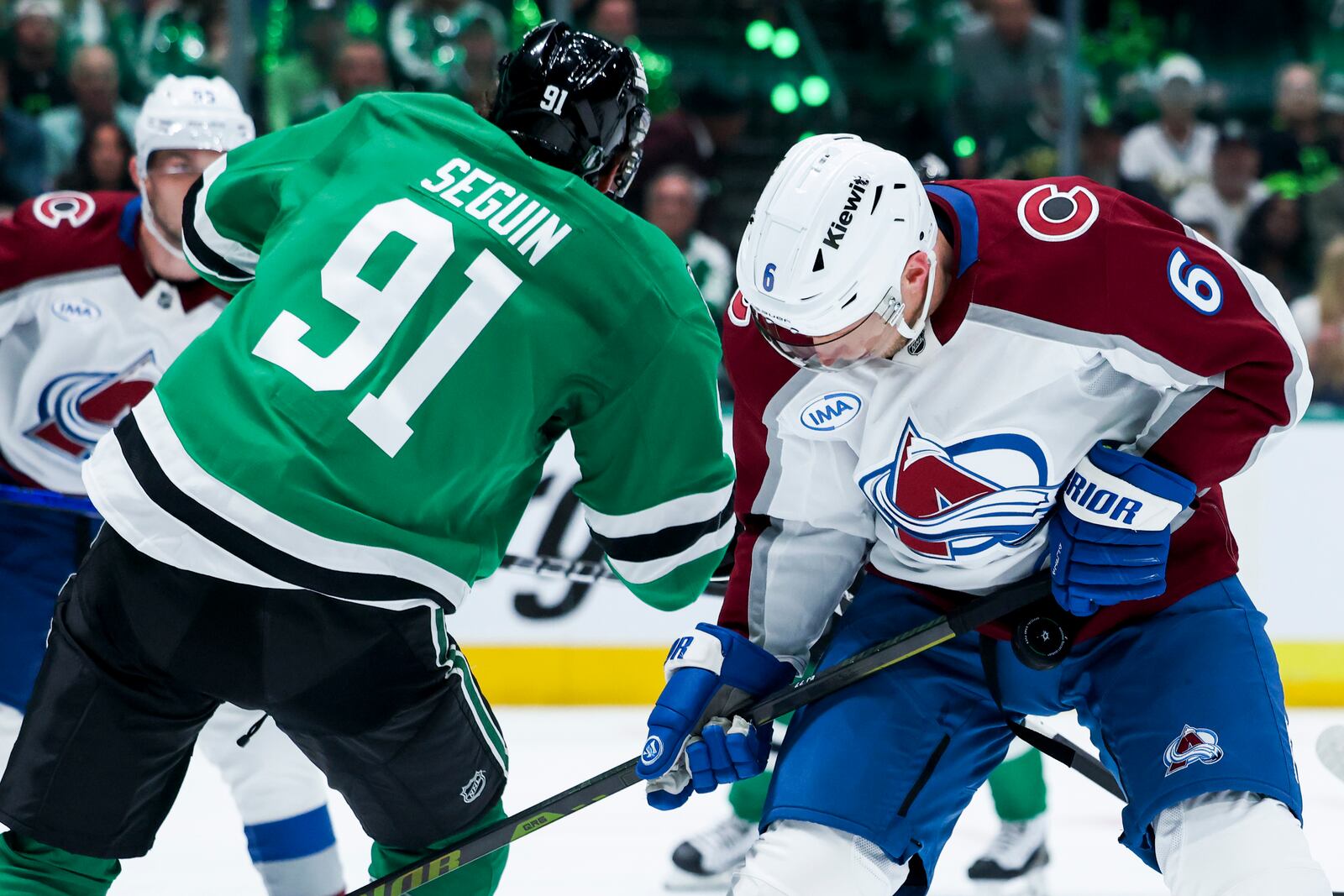 Dallas Stars center Tyler Seguin (91) and Colorado Avalanche defenseman Erik Johnson (6) collide while fighting for the puck during a first-round NHL hockey playoff game in Dallas, Saturday, April 19, 2025. (AP Photo/Gareth Patterson)