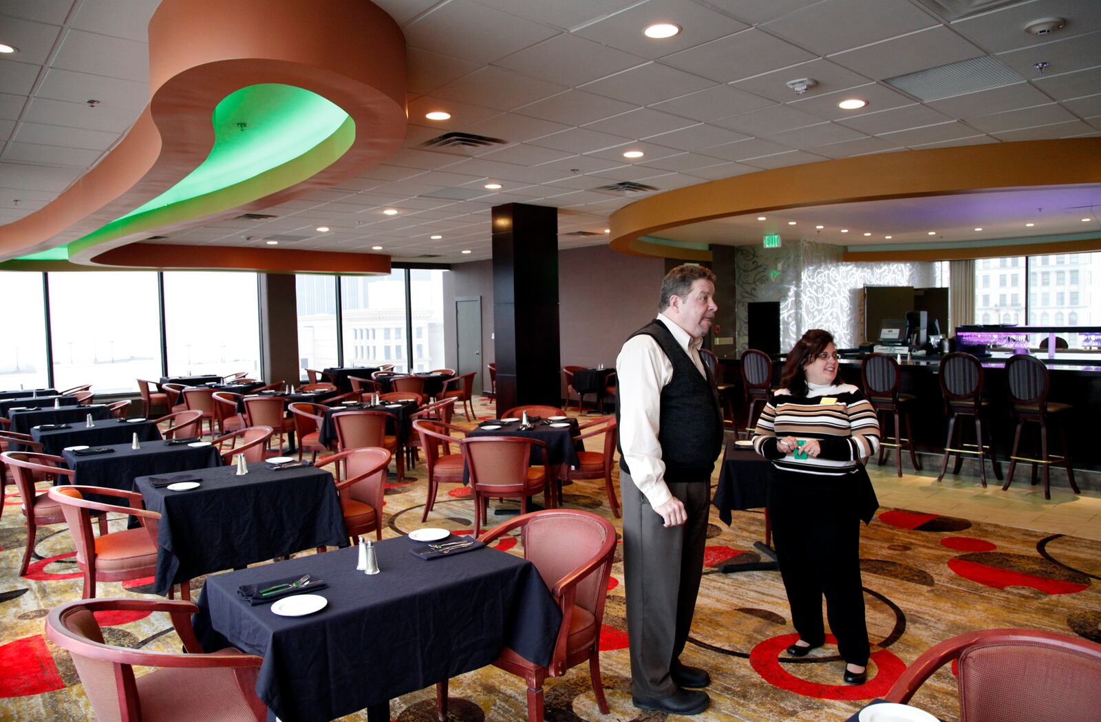 Archive photo of Bill Thomas, director of food and beverage at the Crowne Plaza hotel and Kris Davis, director of sales talk in the renovated Crowne Plaza rooftop restaurant and lounge. (Staff photo by Lisa Powell)
