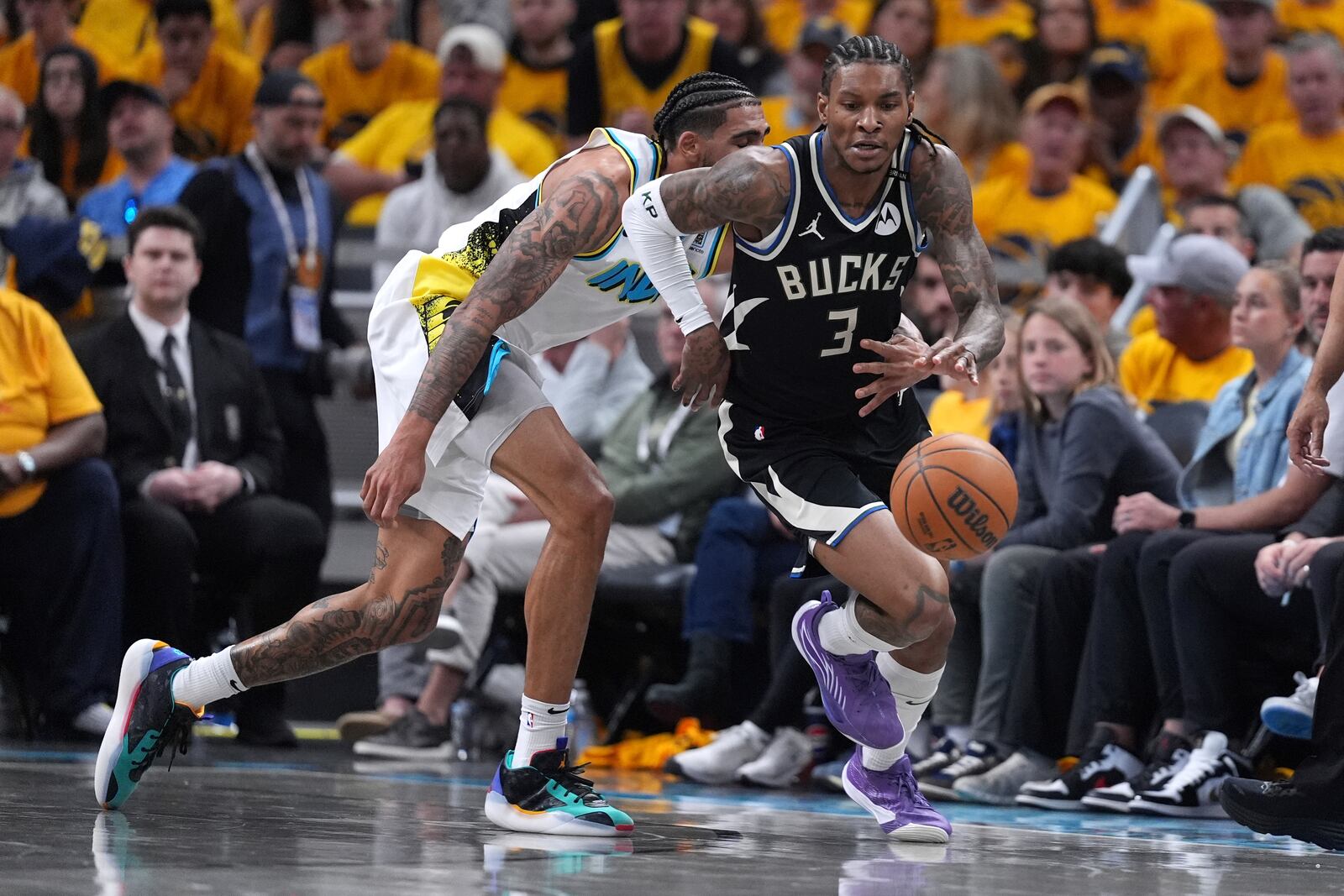 Milwaukee Bucks' Kevin Porter Jr. (3) and Indiana Pacers' Obi Toppin Cheerleaders perform during the second half of a first-round NBA basketball playoff game, Saturday, April 19, 2025, in Indianapolis. (AP Photo/Michael Conroy)