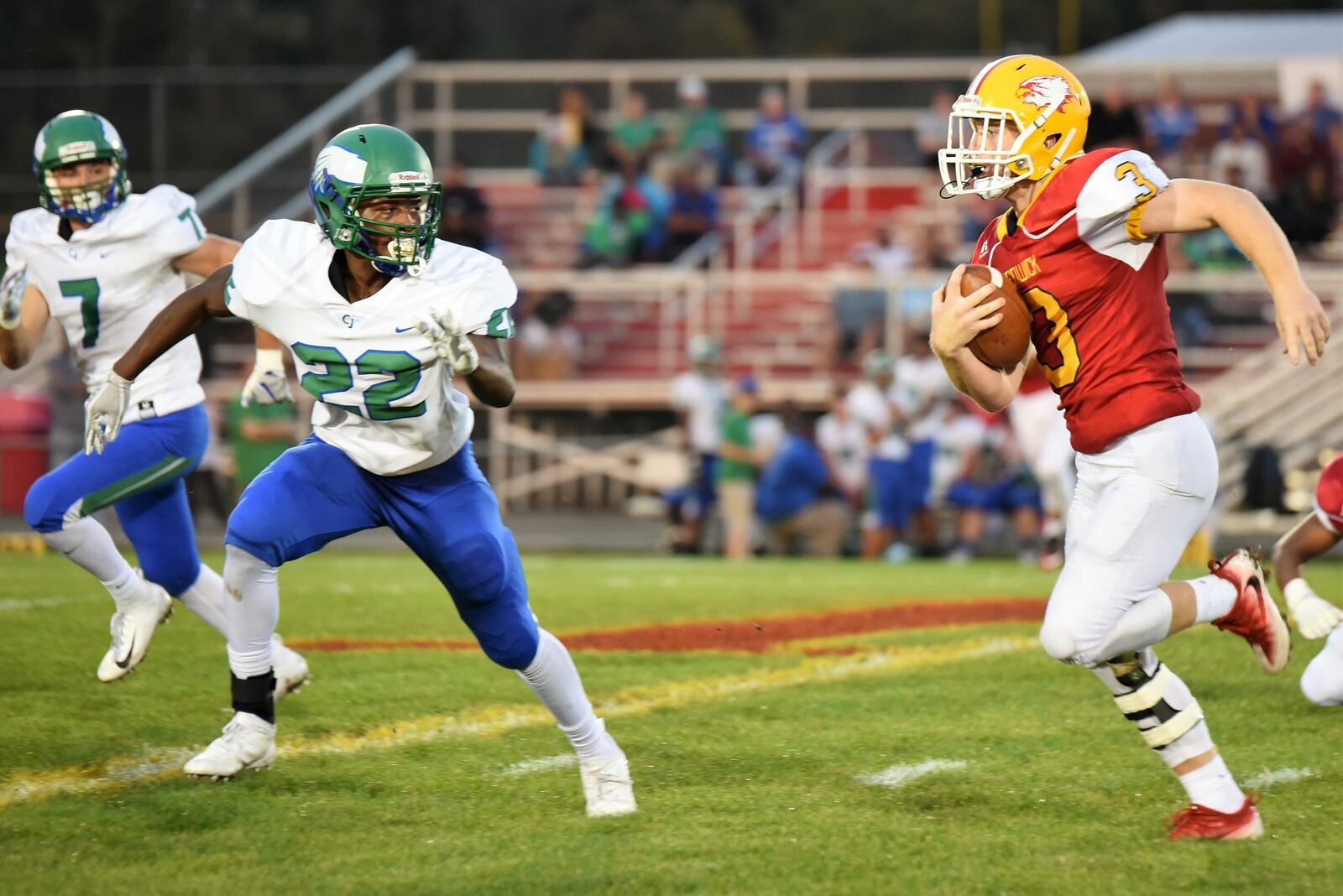 Fenwick’s Jack Fessler (3) prepares to sprint past Chaminade Julienne’s Jason Ward (22) and Brendan Kadel (7) for his second touchdown of the night during Friday’s game at Krusling Field in Middletown. The host Falcons won 34-19. CONTRIBUTED PHOTO BY ANGIE MOHRHAUS