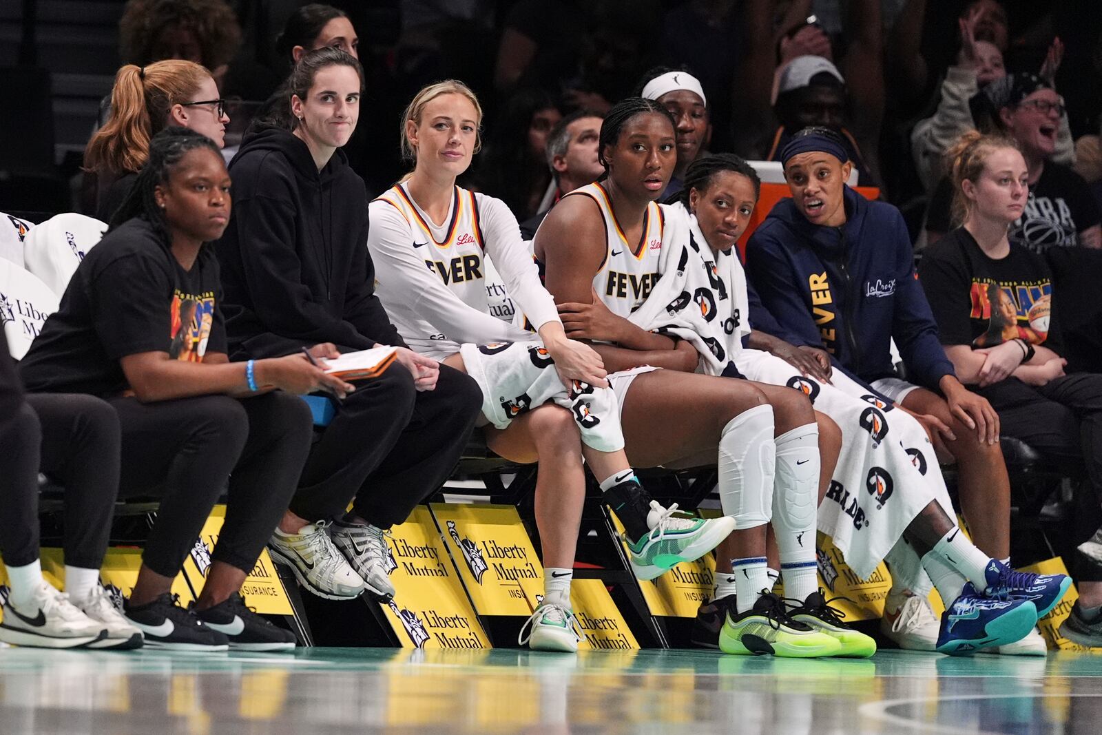Indiana Fever's Caitlin Clark, third from left, and Sophie Cunningham react with teammates to a three-point shot by New York Liberty's Marine Johannes during the second half of a WNBA basketball game Wednesday, July 16, 2025, in New York. (AP Photo/Frank Franklin II)