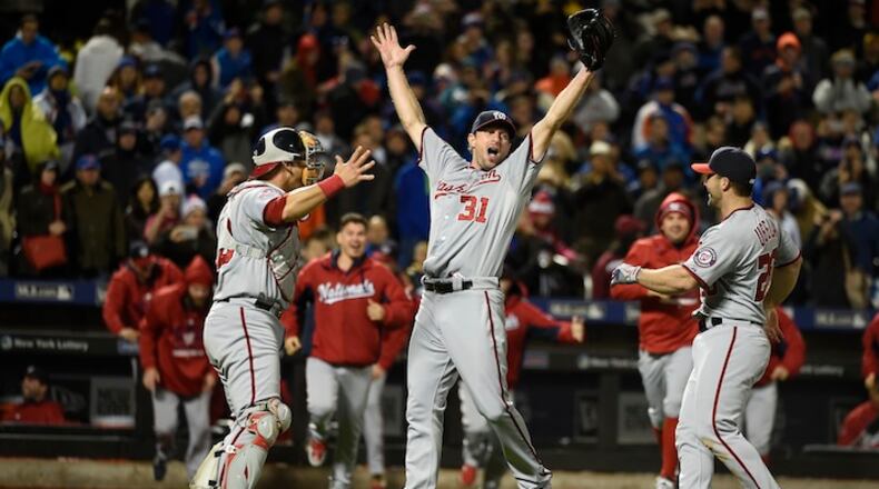 Washington Nationals starting pitcher Max Scherzer (31) celebrates his no hitter against the New York Mets with catcher Wilson Ramos (40), Dan Uggla (26), and teammates in the second baseball game of a doubleheader, Saturday, Oct. 3, 2015, in New York. The Nationals won 2-0. (AP Photo/Kathy Kmonicek)