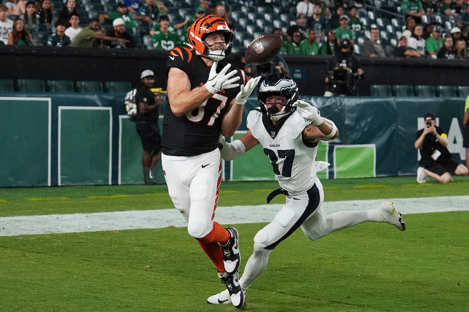 Cincinnati Bengals tight end Tanner Hudson (87) catches the ball for a touchdown in front of Philadelphia Eagles safety Maxen Hook (37) during the second half of an NFL preseason football game Thursday, Aug. 7, 2025, in Philadelphia. (AP Photo/Matt Slocum)