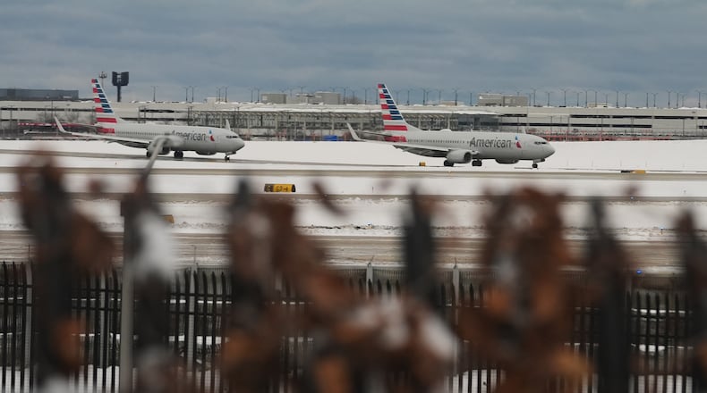 American Airlines planes taxi to terminals at the O'Hare International Airport in Chicago, Sunday, Nov. 30, 2025. (AP Photo/Nam Y. Huh)