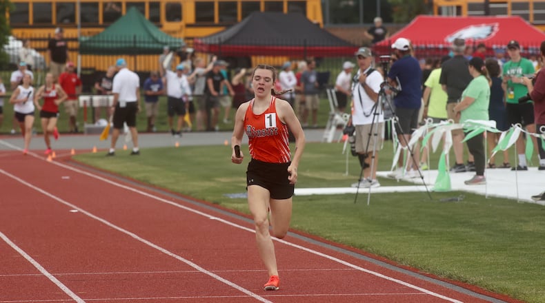 Minster's Claire Bohman races to victory on the final leg of the 4x800 relay at the Division III state track and field championships on Friday, June 6, 2025, at Jesse Owens Memorial Stadium in Columbus.