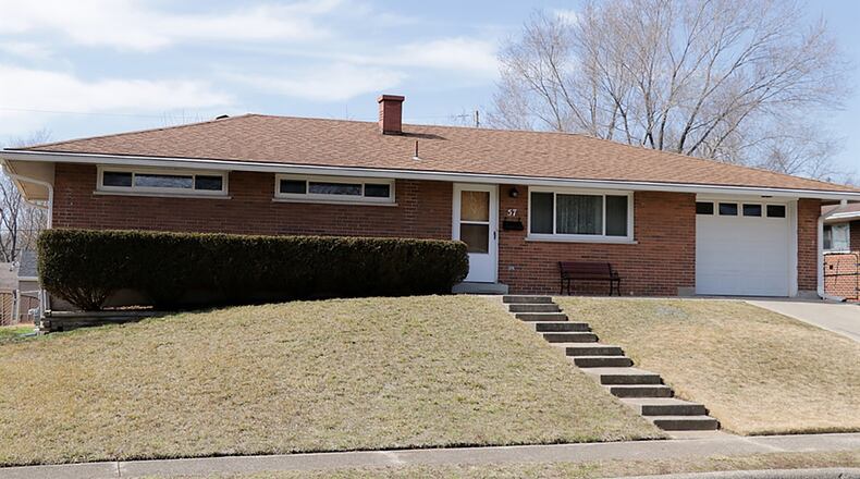 The brick ranch with about 1,070 sq. ft. of living space has a full, semi-finished basement, 3 bedrooms and full bathroom. The house sits high off the sidewalk with concrete steps that lead up to the front door. CONTRIBUTED PHOTO BY KATHY TYLER