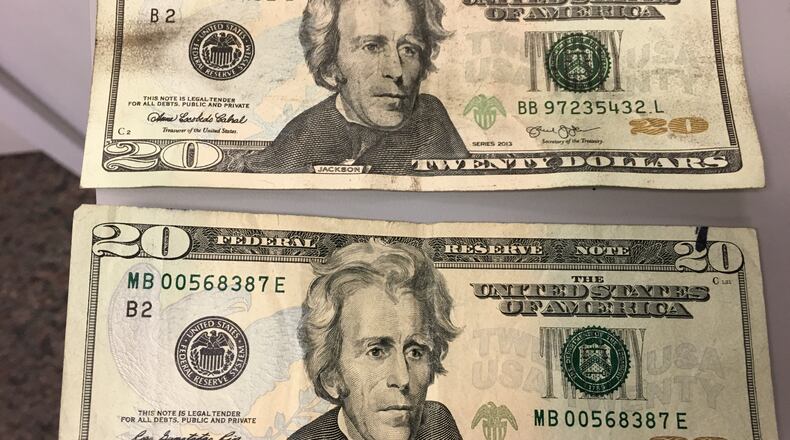 Kenneth J. Stopkotte was found with several fake $20 bills during an April Dayton Dragons game, investigators alleged. One of the fakes (above) is shown with a real $20 bill. MARK GOKAVI/STAFF