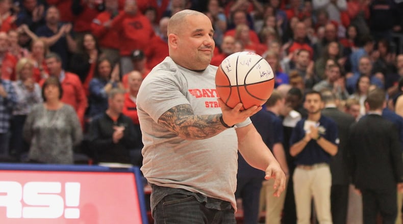 Jeremy Ganger is honored during a game between Dayton and George Washington on Saturday, March 7, 2020, at UD Arena. David Jablonski/Staff