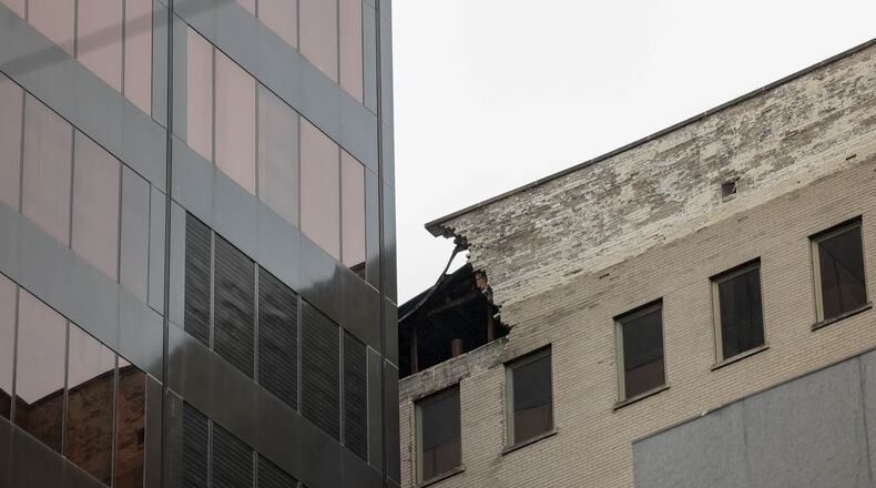 A view of the building formerly occupied by Key Bank at 34 N. Main St., which neighbors Stratacache Tower on Main Street. Part of the building's upper facade collapsed on Saturday afternoon, causing damage of Stratacache Tower. The Dayton Fire Department blocked off Main Street and also blocked off an alley between North Jefferson Street and Main Street. BRYANT BILLING/STAFF