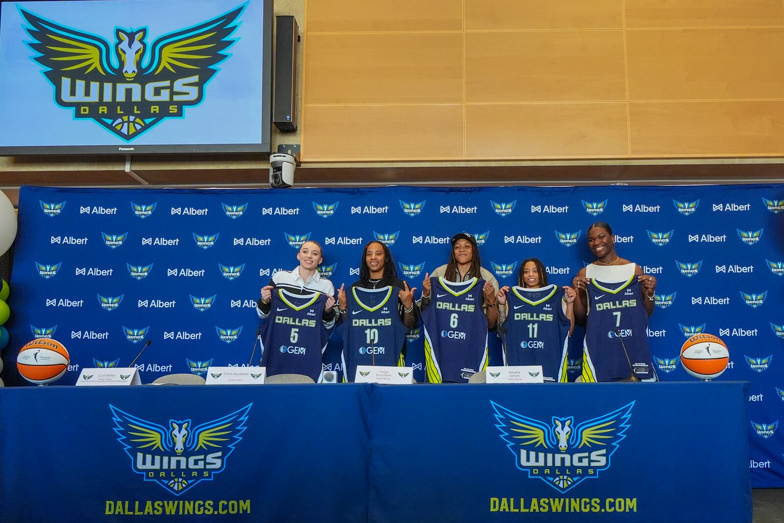Dallas Wings' WNBA basketball draft selection, from left, Paige Bueckers, Aziaha James, Madison Scott, JJ Quinerly and Aaronette Vonleh pose for photographs during an introductory press conference Wednesday, April 23, 2025, in Dallas. (AP Photo/Julio Cortez)