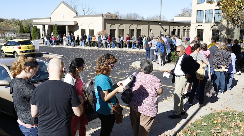 A line of voters stretches out the door and around the parking lot of the Clark County Board of Elections as people wait for over an hour to cast their vote Monday before early voting closes at 2p.m. Bill Lackey/Staff
