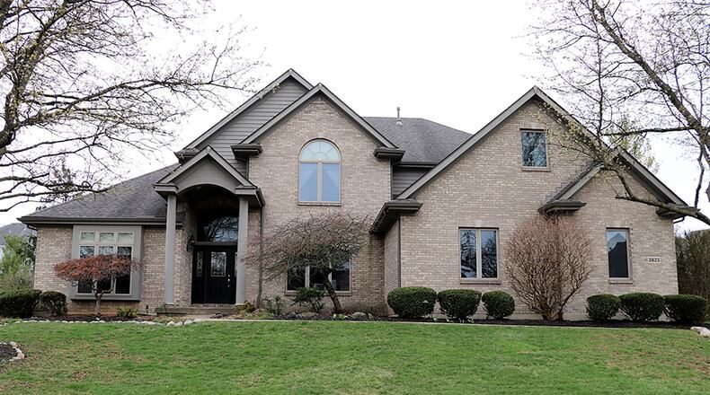 The brick 2-story has about 5,090 sq. ft. of living space, including a first-floor main bedroom suite and a full, finished basement. Located in Tara Estates of Beavercreek, the property has a side-entry, 3-car garage with extra parking pad, a fenced tree-lined back yard and in-ground pool. CONTRIBUTED PHOTO BY KATHY TYLER