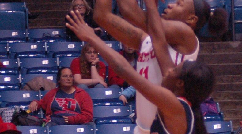 Dayton’s Alex Harris gets a shot off over a Morgan State defender Friday night at UD Arena. JOHN CUMMINGS/CONTRIBUTED