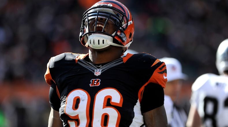 Cincinnati Bengals defensive end Carlos Dunlap celebrates after tackled an Oakland Raiders player. The Bengals defeated the Oakland Raiders 34-10 during their Sunday, Nov. 25, 2012 game at Paul Brown Stadium. file photo