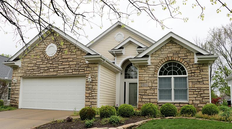 The custom-built patio home with 2 or 3 bedrooms has about 1,970 sq. ft. of living space. The property is located on a cul-de-sac within the Wedgestone section of Yankee Trace Golf Course community. A concrete driveway leads up to a 2-car garage, and stone accents mature landscaping. CONTRIBUTED PHOTO BY KATHY TYLER