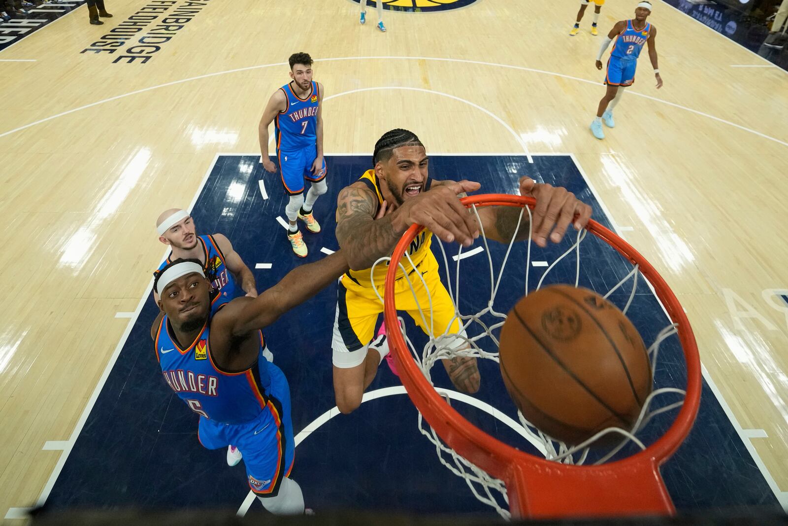 Indiana Pacers forward Obi Toppin (1) dunks over Oklahoma City Thunder guard Luguentz Dort (5) during the second half of Game 3 of the NBA Finals basketball series, Wednesday, June 11, 2025, in Indianapolis. (AP Photo/Abbie Parr)