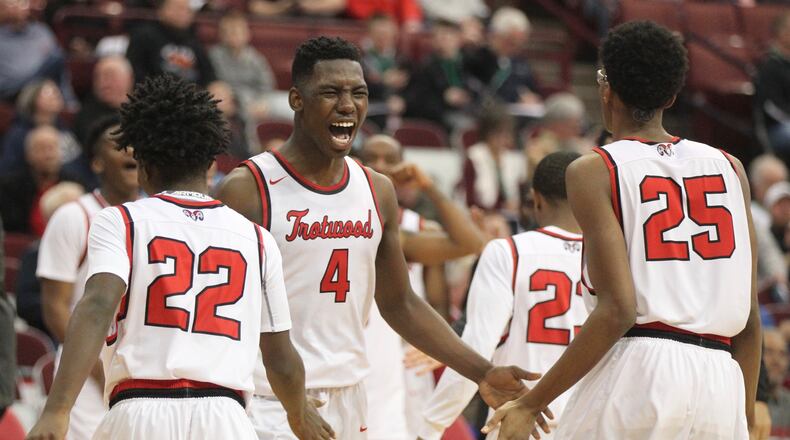 Trotwood-Madison’s Myles Belyeu (4) celebrates a victory against Meadowbrook in a Division II state semifinal on Friday, March 23, 2018, at the Schottenstein Center in Columbus. David Jablonski/Staff
