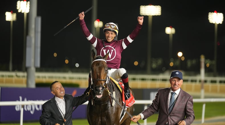 Jockey Jose Ortiz, aboard Magnitude, celebrates winning the $12 million Dubai World Cup horse race over 2000m (10 furlongs) at Meydan Racecourse in Dubai, the United Arab Emirates, Saturday, March 28, 2026. (AP Photo/Altaf Qadri)