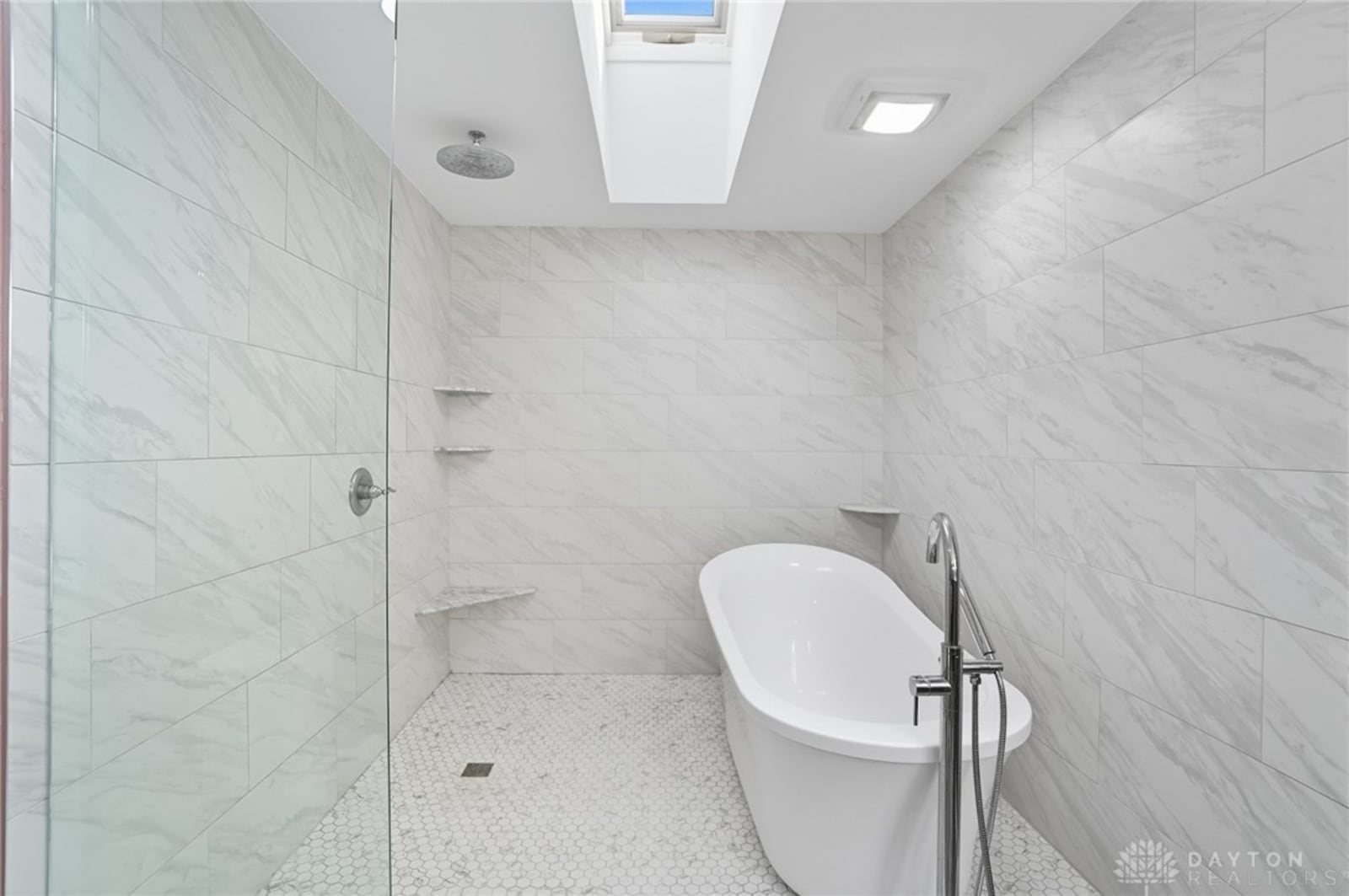 The primary ensuite bathroom features a walk in shower and freestanding bathtub. CONTRIBUTED
