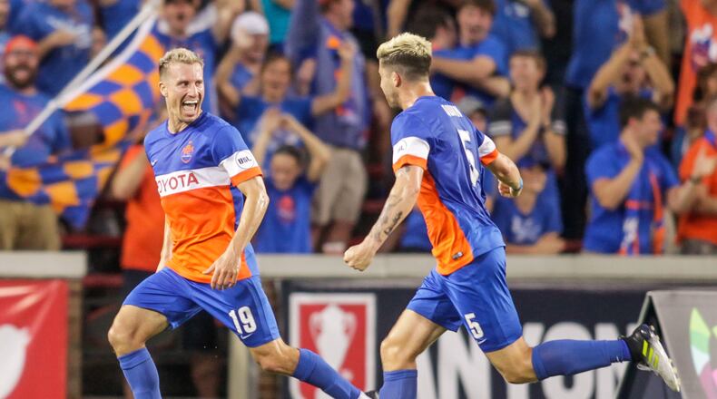 FC Cincinnati’s Corben Bone, left, and Aodhan Quinn celebrate Bone’s goal during their 2017 Lamar Hunt U.S. Open Cup semifinal game against New York Red Bulls Tuesday, Aug. 15, 2017 at Nippert Stadium on the University of Cincinnati Campus in Cincinnati. NICK GRAHAM/STAFF