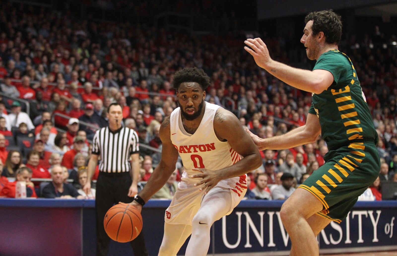 Dayton's Josh Cunningham drives to the basket against George Mason on Wednesday, Jan. 23, 2019, at UD Arena.