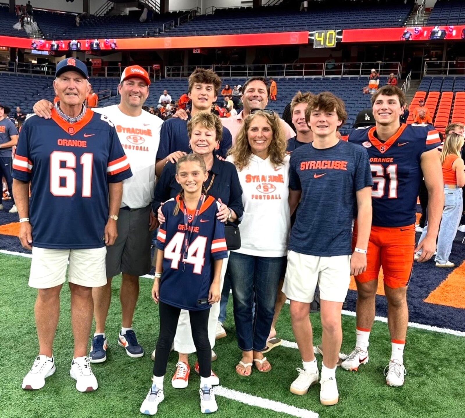Jim Stangle and the Stangle Family: (front row granddaughter Audrey (No 44); (second row) wife Judy, Ali, Reid. (Back Row)  Jim, son Matt (who played at UD), Gray, son Ryan (who played at UD), Brady. and grandson Ethan (the long snapper for Syracuse). CONTRIBUTED PHOTO