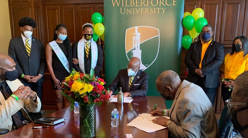 Wilberforce University president and the director of the Dayton Job Corps sign an agreement allowing students of both institutions to take classes at each.