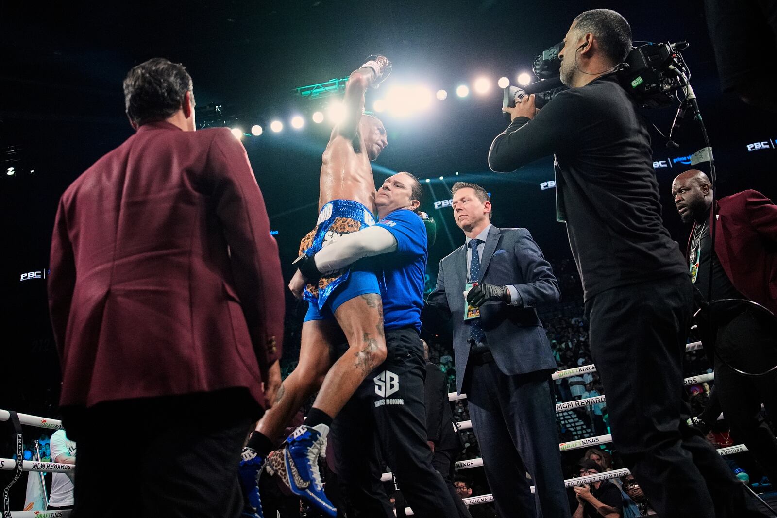 Mario Barrios, center, reacts after fighting to a majority draw against Manny Pacquiao in a welterweight title boxing match Saturday, July 19, 2025, in Las Vegas. (AP Photo/John Locher)