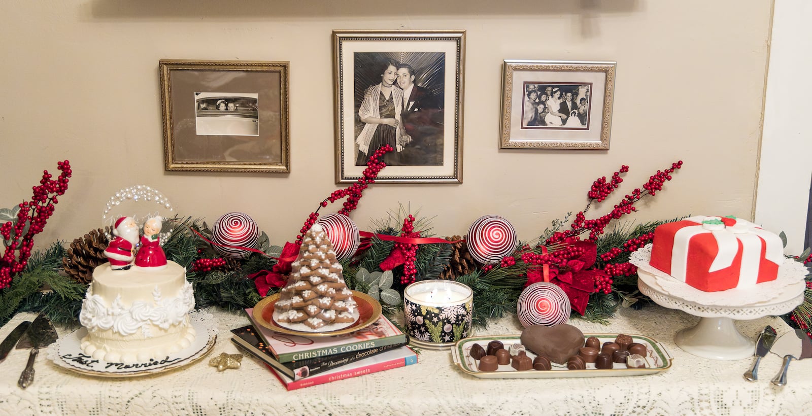 Wedding photos of Isabel Suarez's parents are on a wall in her kitchen above where she staged desert foods during a wedding ceremony on Friday, Dec. 26 in Dayton. BRYANT BILLING/STAFF